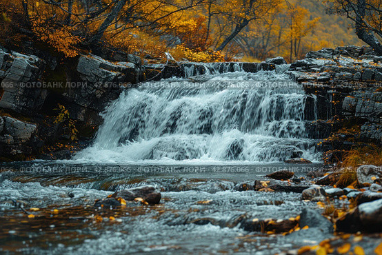 Picturesque waterfall in the forest in autumn. The water rushes forcefully over multi-level rocky rapids, creating a striking contrast with the warm colors of the autumn foliage surrounding the pond. The leaves of the trees, painted in golden and copper tones, glow against the background of dark blue water and stones, which adds peace and harmony to the scene. Стоковое AI-изображение, AI-художник Анна Кривицкая / Фотобанк Лори