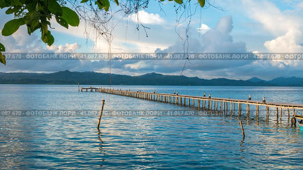 Pier of Dive Station - Kri Island. Clound above Gam in Background. Raja Ampat, Indonesia, West Papua (2016 год). Стоковое фото, фотограф Igor Tichonow / Фотобанк Лори