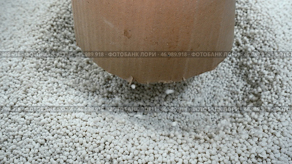 Pile of white plastic pellets in industrial workshop. Стоковое фото, фотограф David Kashakhi / Фотобанк Лори