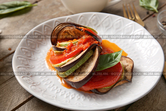 Plate of tasty Ratatouille on wooden background. Стоковое фото, фотограф Pixel_shot / Фотобанк Лори