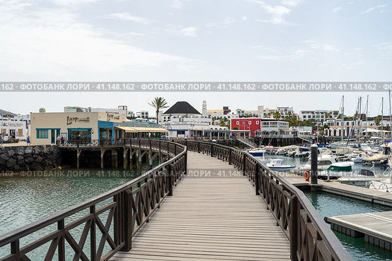 PLAYA BLANCA, LANZAROTE - JULY 18, 2022: Marina Rubicon of Playa Blanca. Playa Blanca is the southernmost town of the Spanish island of Lanzarote. It is the newest resort on the island. Редакционное фото, фотограф Sergey Kohl / Фотобанк Лори