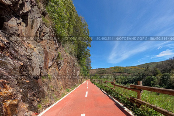 Point of view shot of riding a bicycle in Sever do Vouga, Portugal. Features a wide view of the bike track and the natural scenery. Стоковое фото, агентство Ingram Publishing / Фотобанк Лори
