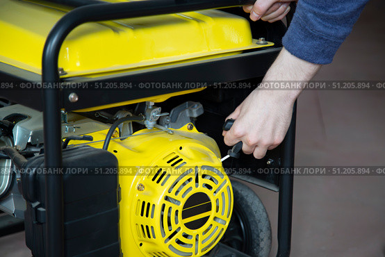 Portable gasoline generator.The use of an autonomous energy source. An additional source of energy. Стоковое фото, фотограф Александр Поташев / Фотобанк Лори