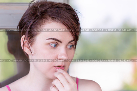 Portrait of a girl, thoughtfully touching her hand to her lips. Стоковое фото, фотограф Татьяна Дворецкая / Фотобанк Лори