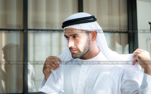 Portrait of a handsome young Arabic man in traditional clothes. Стоковое фото, агентство Ingram Publishing / Фотобанк Лори