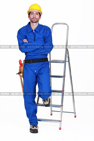 Portrait of a standoffish tradesman with his arms crossed. Стоковое фото, агентство Ingram Publishing / Фотобанк Лори