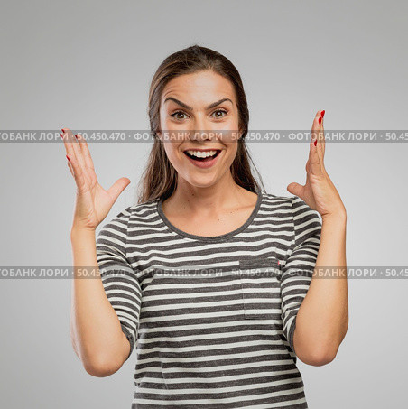 Portrait of a woman after receiving great news, over a gray background. Стоковое фото, агентство Ingram Publishing / Фотобанк Лори