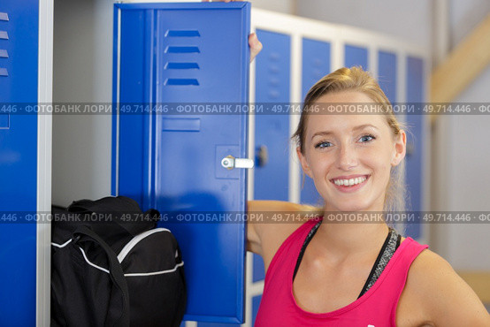 portrait of beautiful woman at her locker in sports center. Стоковое фото, агентство Ingram Publishing / Фотобанк Лори