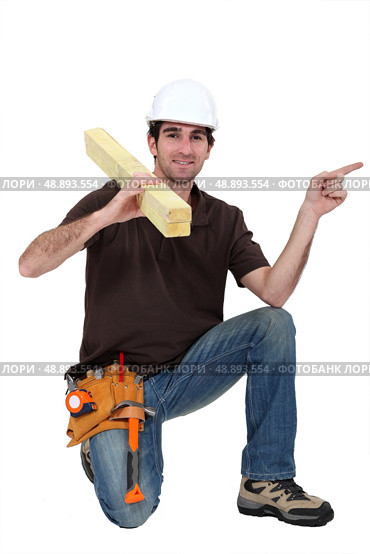 portrait of carpenter isolated pointing sidewards isolated on white. Стоковое фото, агентство Ingram Publishing / Фотобанк Лори