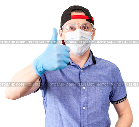 Portrait of delivery man gesturing wearing thumb up sign, wearing safety glasses, surgical mask and blue neoprene gloves, solated on white background. Стоковое фото, фотограф Кекяляйнен Андрей / Фотобанк Лори
