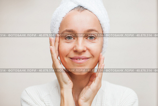 portrait of gorgeous happy middle age woman looking at mirror touching her skin. Стоковое фото, фотограф Гладских Татьяна / Фотобанк Лори