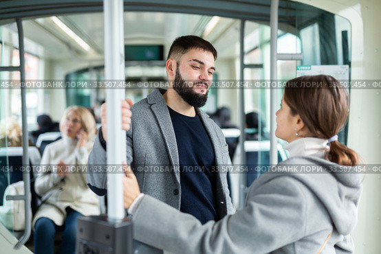 Portrait of playful positive people making acquaintance in public transport. Стоковое фото, фотограф Яков Филимонов / Фотобанк Лори