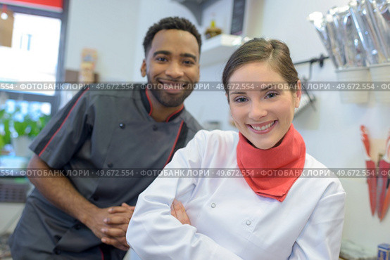 portrait of smiling male and female bakers. Стоковое фото, агентство Ingram Publishing / Фотобанк Лори