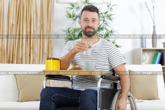 positive delighted invalid man having breakfast. Стоковое фото, агентство Ingram Publishing / Фотобанк Лори