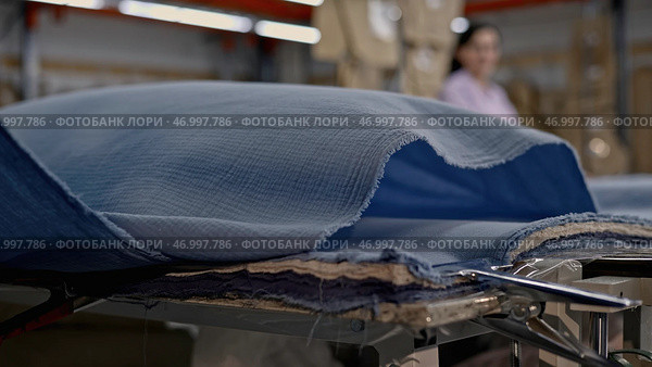 Preparing to work with material, embroidery clothes for large customized order, future navy blue evening dress. Стоковое фото, фотограф David Kashakhi / Фотобанк Лори