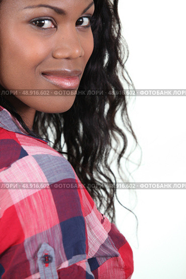 Pretty young woman in a checked shirt. Стоковое фото, агентство Ingram Publishing / Фотобанк Лори