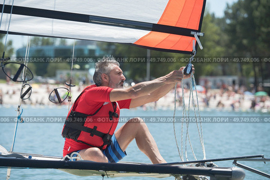 professional waterman training on lake with catamaran. Стоковое фото, агентство Ingram Publishing / Фотобанк Лори