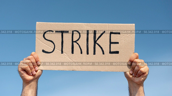 protester holding board with strike. Стоковое фото, агентство Ingram Publishing / Фотобанк Лори