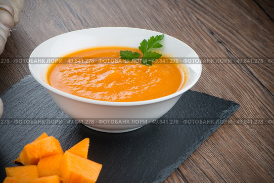 Pumpkin soup on white wood background. Стоковое фото, агентство Ingram Publishing / Фотобанк Лори