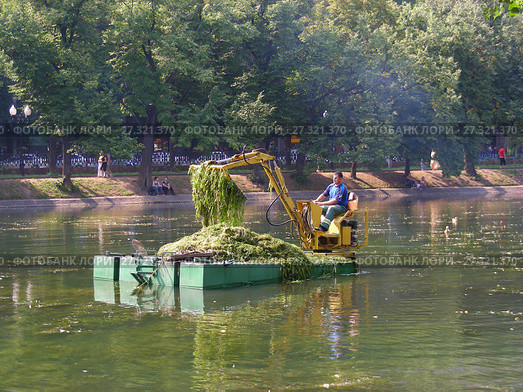 Рабочий на плавающем экскаваторе очищает от водорослей водоем. Чистые Пруды. Басманный район. Город Москва (2008 год). Редакционное фото, фотограф lana1501 / Фотобанк Лори
