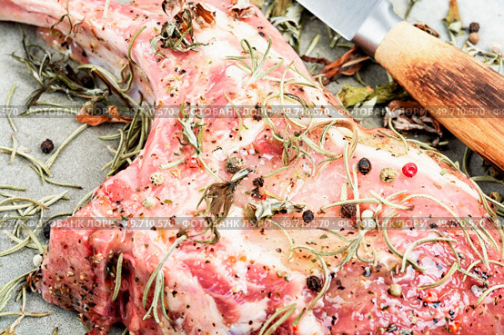 Raw pork steak Tomahawk marinated in spicy herbs. Preparation dinner.. Raw pork uncooked steak Tomahawk. Стоковое фото, агентство Ingram Publishing / Фотобанк Лори