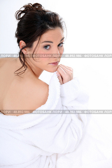 Rear shot of woman removing bathing robe. Стоковое фото, агентство Ingram Publishing / Фотобанк Лори