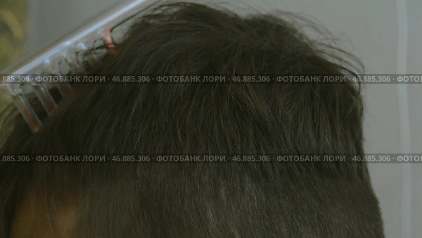Receiving electric darsonval body, neck and back massage procedure against pain, Medical Spa treatment, Professional cosmetologist undergoing darsonvalization on skin, body care. Стоковое фото, фотограф David Kashakhi / Фотобанк Лори