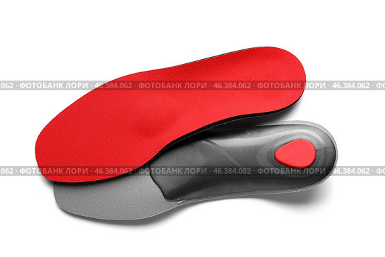 Red orthopedic insoles on white background. Стоковое фото, фотограф Pixel_shot / Фотобанк Лори