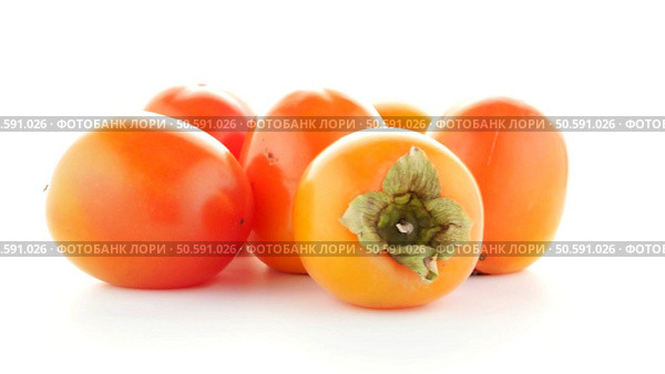 Red ripe persimmons rotating over white background. Стоковое фото, агентство Ingram Publishing / Фотобанк Лори