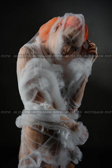 Red woman artistically entangled in a delicate net trap. Стоковое фото, фотограф Гурьянов Андрей / Фотобанк Лори