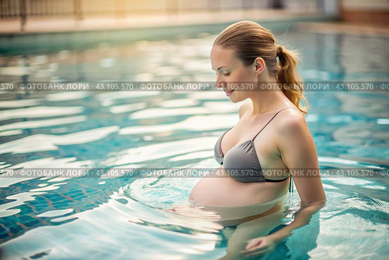 Relaxation, peace of mind. Pregnant, beautiful woman, in an outdoor heated pool. The concept of pregnancy, childbirth and parenthood. Healthy lifestyle. Стоковое AI-изображение, AI-художник Photojuli / Фотобанк Лори
