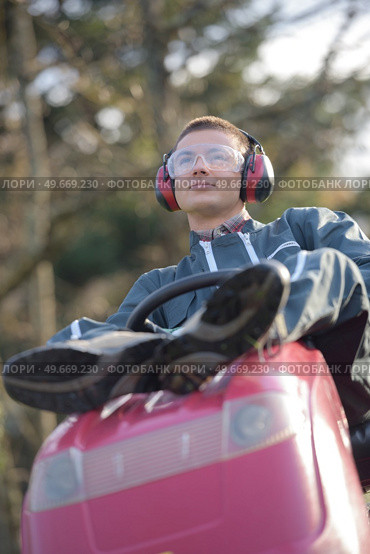 resting on the tractor mower. Стоковое фото, агентство Ingram Publishing / Фотобанк Лори