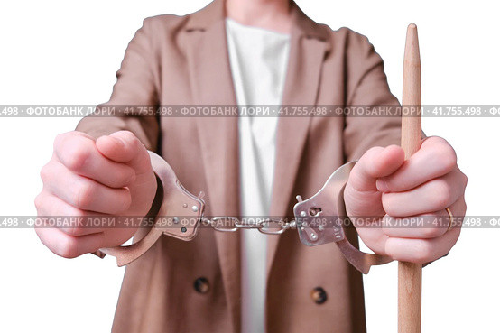 Restrained woman teacher handcuffed on a isolated on a white background, copy space. Стоковое фото, фотограф Андрей Журавлев / Фотобанк Лори
