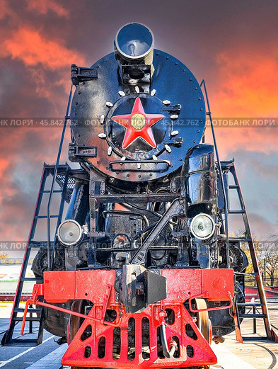 Revolutionary steam locomotive with red star against the backdrop of an alarming crimson sky. Стоковое фото, фотограф FotograFF / Фотобанк Лори