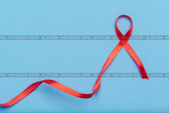 ribbon HIV, AIDS on blue background. Стоковое фото, фотограф Сергей Толмачёв / Фотобанк Лори