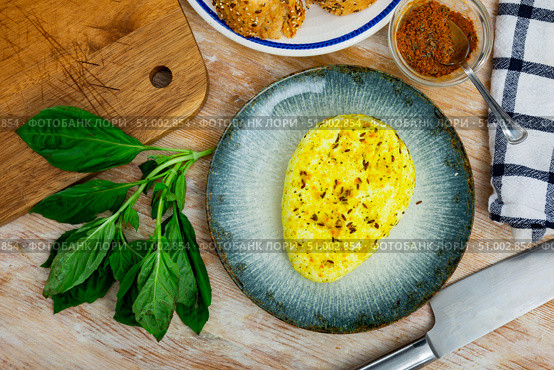 Roasted cottage cheese with turmeric and cumin on plate with baguette and greens. Стоковое фото, фотограф Яков Филимонов / Фотобанк Лори