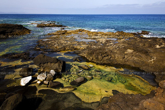 rock stone sky cloud beach  water  coastline and summer in lanzarote spain. Стоковое фото, агентство Ingram Publishing / Фотобанк Лори