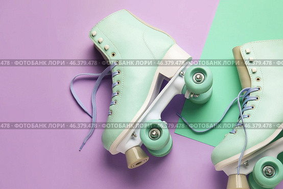 Roller skates with untied laces on color background, closeup. Стоковое фото, фотограф Pixel_shot / Фотобанк Лори
