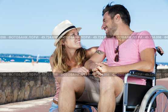 romantic young couple by the seaside man in wheelchair. Стоковое фото, агентство Ingram Publishing / Фотобанк Лори