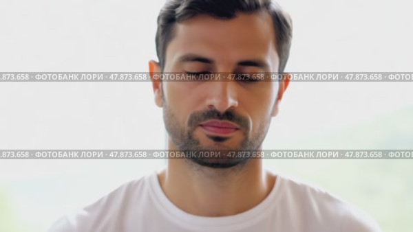 Sad depressed man in depression and bad mood, looking down and touching forehead, loneliness and pain concept. Fighting with yourself, meditation. Стоковое AI-видео, аниматор ALLA YURTAYEVA / Фотобанк Лори
