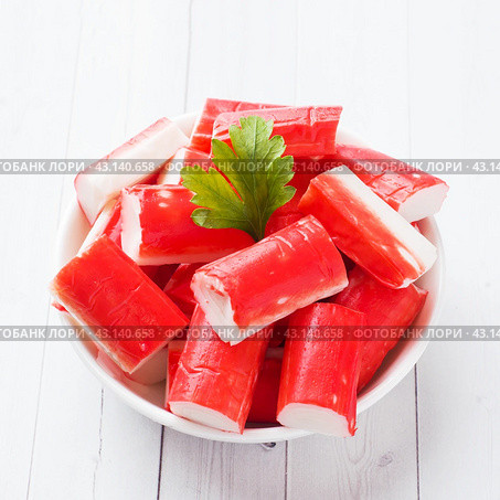 Salad crab sticks in a plate on a white table. Стоковое фото, фотограф Глущенко Елена / Фотобанк Лори