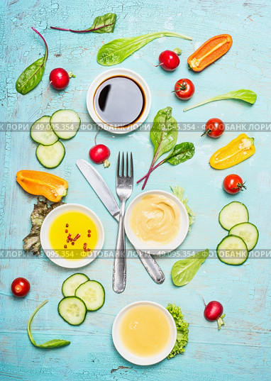 Salad dressing ingredients: vinegar ,mustard,oil and honey with vegetables. Cutlery with salad ingredients, top view. Flat lay of healthy  lifestyle or detox diet food  concept, Стоковое фото, агентство Ingram Publishing / Фотобанк Лори