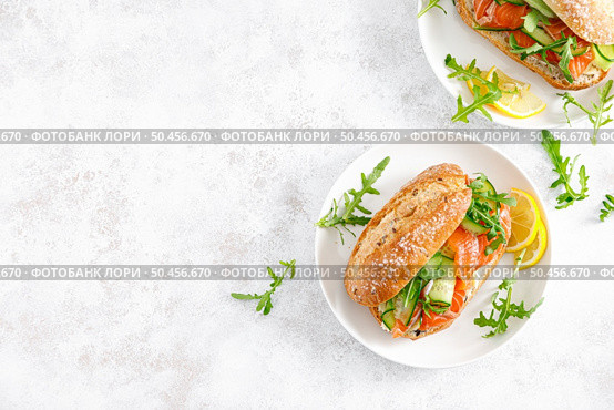 Sandwiches with salted salmon, arugula and cucumber. Breakfast. Top view. Стоковое фото, агентство Ingram Publishing / Фотобанк Лори