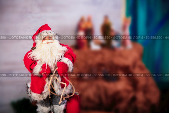 Santa Claus as Toy in red suit costume in a cap and gold-rimmed glasses with a blush on the cheeks carry gifts sale, market, realization in the shop, supermarket. Стоковое фото, агентство Ingram Publishing / Фотобанк Лори