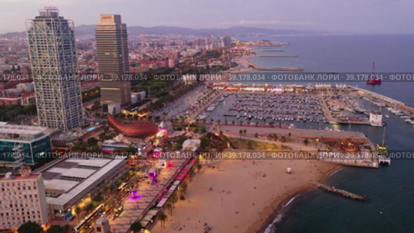 Scenic aerial panoramic view of modern Barcelona cityscape on Mediterranean coast with marina at summer twilight, Spain. Стоковое видео, видеограф Яков Филимонов / Фотобанк Лори