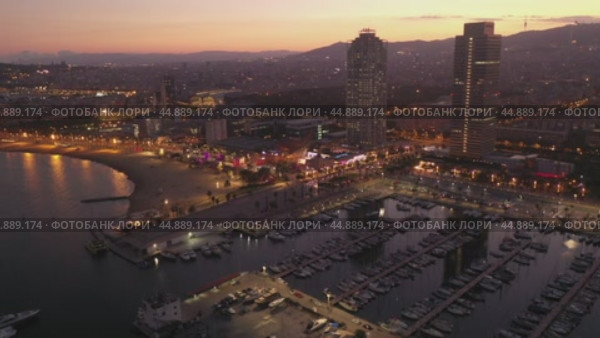 Scenic aerial panoramic view of modern Barcelona cityscape on Mediterranean coast with marina at summer twilight, Spain. Стоковое видео, видеограф Яков Филимонов / Фотобанк Лори