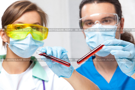 Scientists with test tubes show. Стоковое фото, фотограф Astroid / Фотобанк Лори