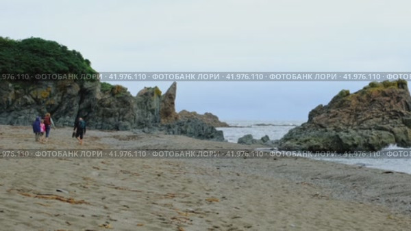 Семья с детьми путешествуют по морскому побережью с рюкзаками на спине. Стоковое видео, видеограф Эльвира  Трощенкова / Фотобанк Лори