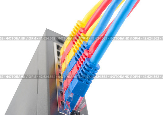 Сетевой коммутатор с подключенными разноцветными сетевыми кабелями. Closeup of network cables connected to router on white. Стоковое фото, фотограф Татьяна Д / Фотобанк Лори