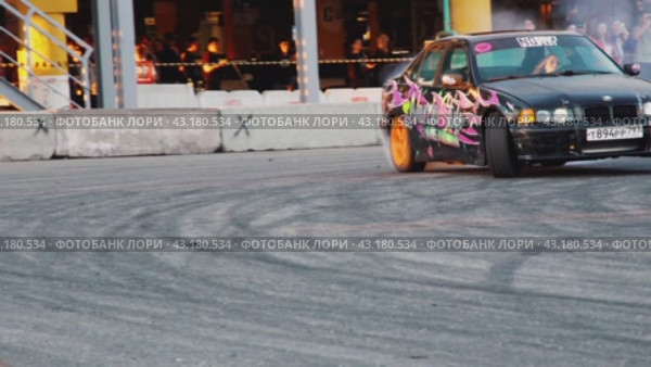 Severe sideways skidding of the car when turning on asphalt. Performances of drift masters at an amateur festival at the Mega Belaya Dacha site. Russia. Moscow. 19.05.2024. Редакционное видео, видеограф Ярославский Максим / Фотобанк Лори
